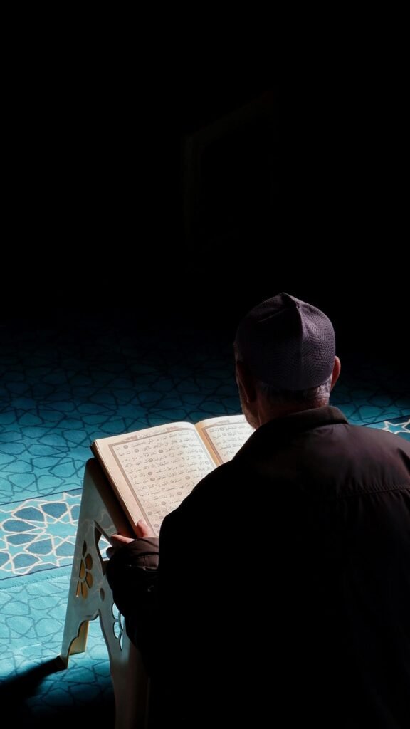 a male sitting on a desk studying spiritual courses