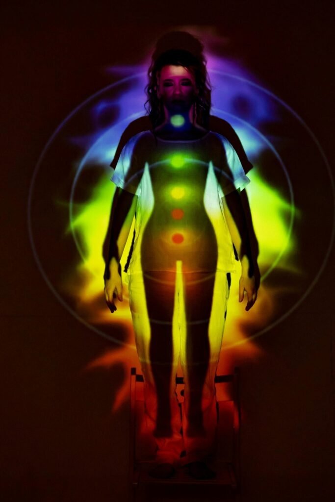 a colourful picture of a female body with her 7 energy centres glowing after a chakra healing session