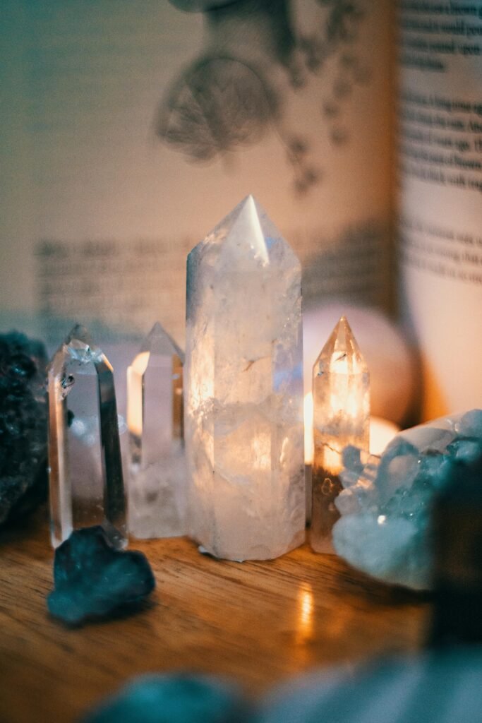 Beautiful quartz crystals displayed on a wooden table with warm ambient lighting showing the spiritual products available